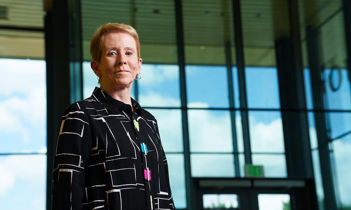 Andrea Harral stands in front of a building on the O U campus.