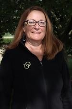 A headshot of Kathy Meerhaeghe outdoors.